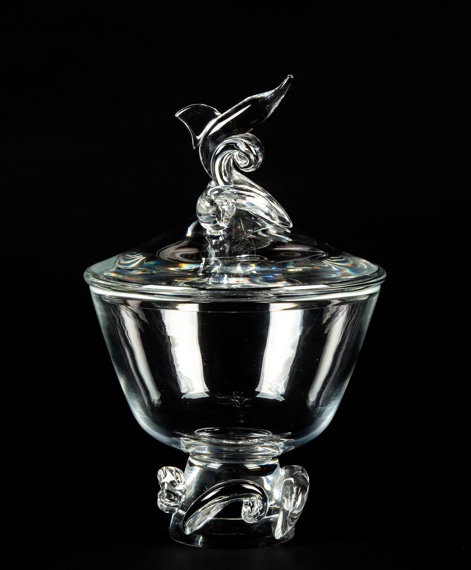 "Steuben" Glass Covered Compote with Sailfish Finial: "Steuben" Glass Covered Compote with Sailfish Finial, Having a conical shaped bowl resting on a cone shaped base with four applied comas having a fitted domed lid with a sailfish leaping finial, marke