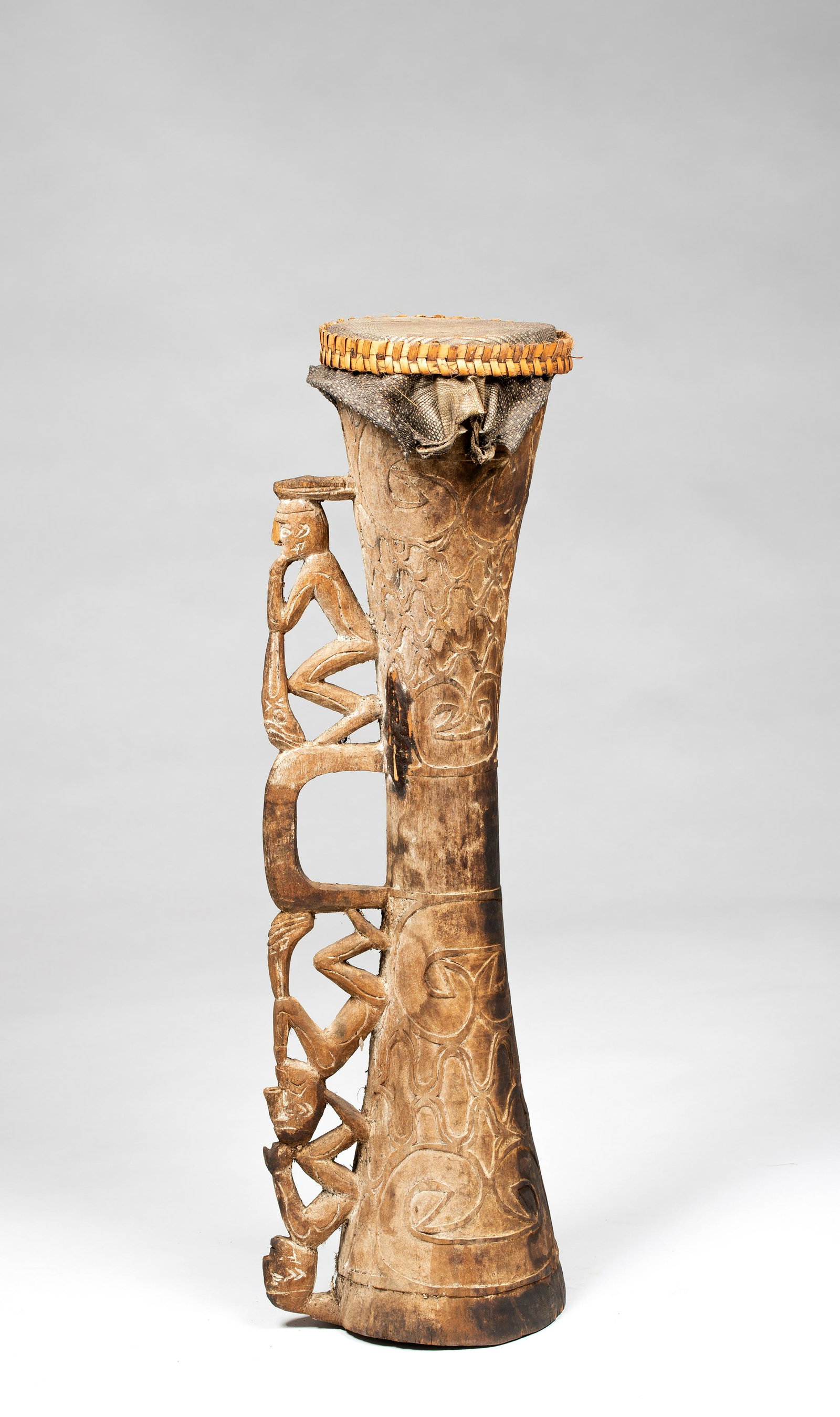 Asmat Drum with Figural Handle, Asmat People, Irian: Exhibited: Traditional Artifacts From the South Pacific, University Gallery, University of Massachusetts at Amherst, Nov-Dec 1991.Asmat Drum with Figural Handle, Asmat People, Irian Jaya, Indonesia. F