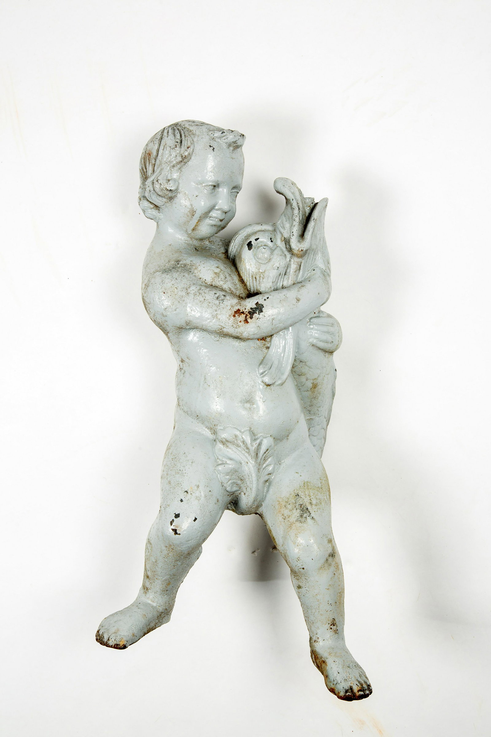 Old Cast Iron Boy and Dolphin Fountain Spout: Old Cast Iron Boy and Dolphin Fountain Spout, Having multiple old painted surfaces on the standing boy who is holding a dolphin whose upward reaching head allows the water to spout upwards from its mo
