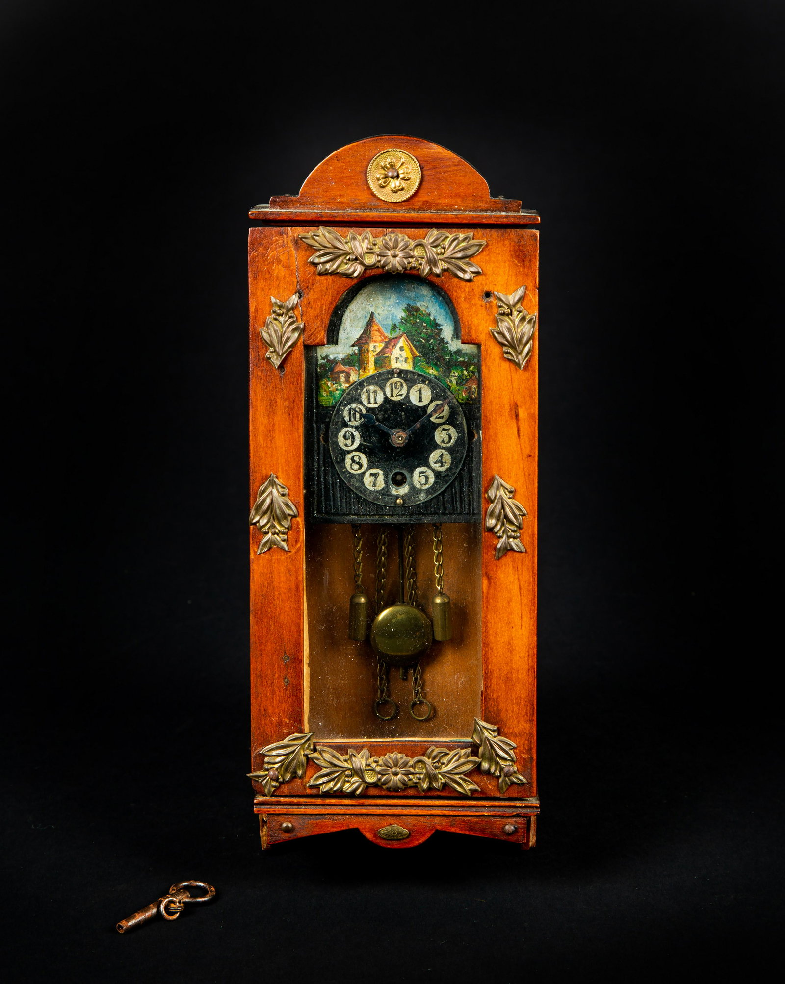 Miniature Continental Wall Clock: Miniature Continental Wall Clock, A biedermeier form with fruitwood case having ormolu decoration, 8 1/2" tall x 3 1/4" wide x 1 3/4" deep, a key wind was on the wall style of movement with faux weigh