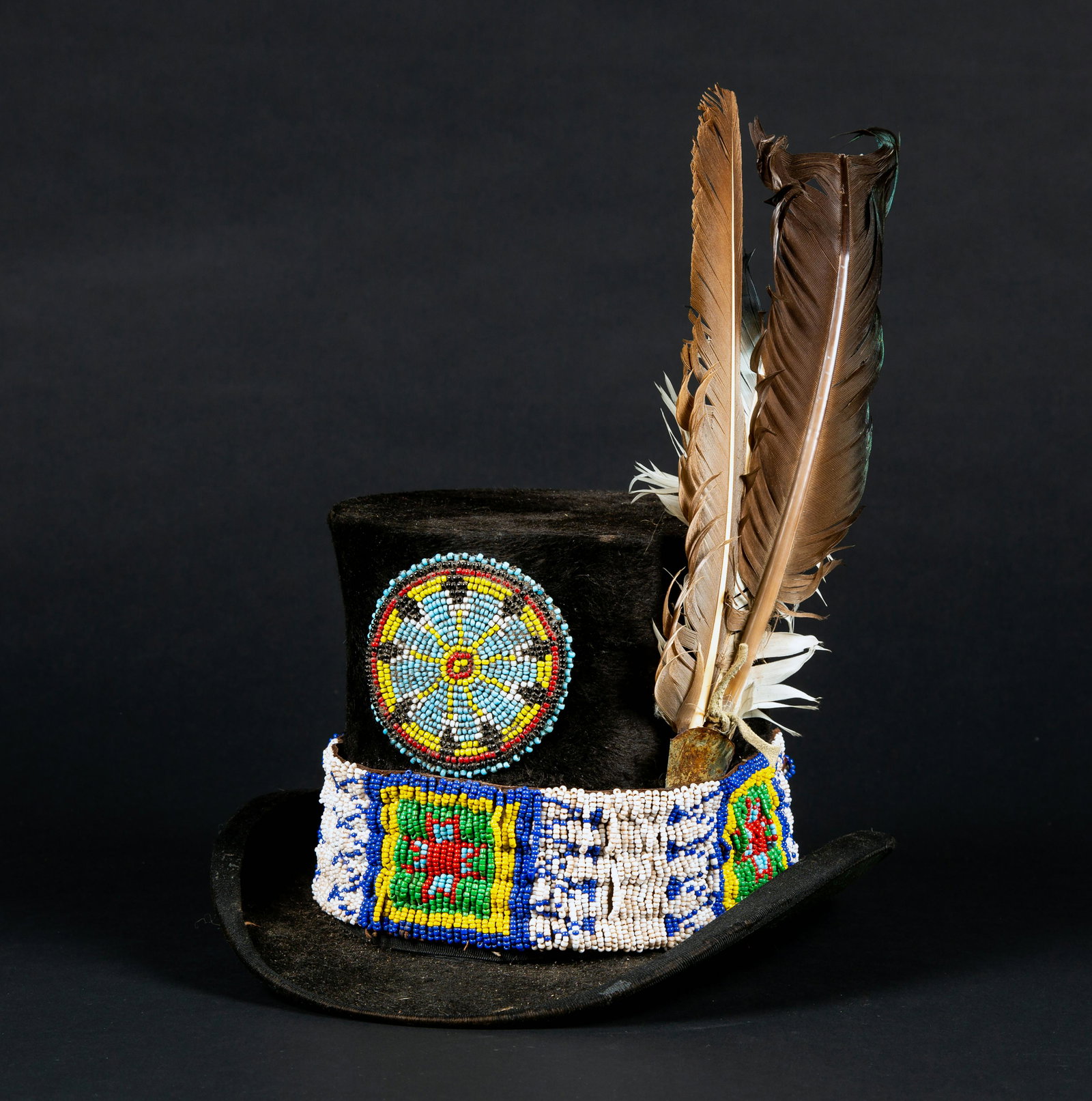 Native American Decorated Top Hat: Native American Decorated Top Hat, This top hat is an old one made by "J. H. Duval Hat Co, Denver, CO" bearing a printed name on the inside of the top, there is a band of beadwork around the base sect