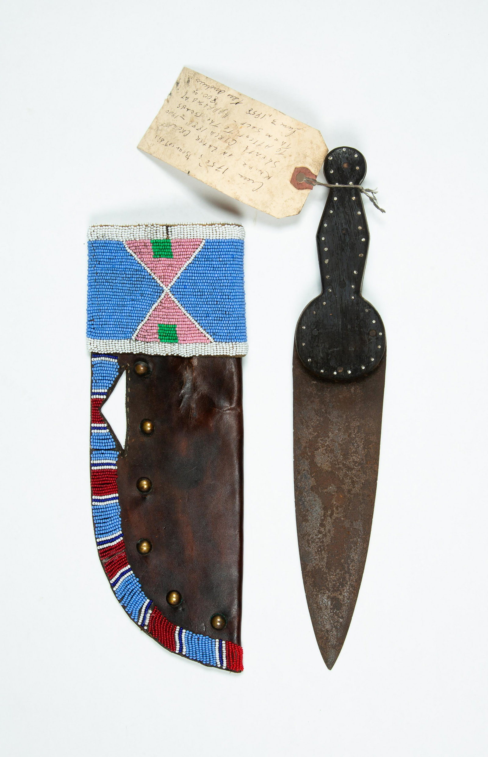 Native American Leather and Bead Decorated Knife Sheath: Native American Leather and Bead Decorated Knife Sheath, This bowie knife sheath is 11" long with a multi colored beadwork band at the top and down the stick joined side, also has six brass tacks as d