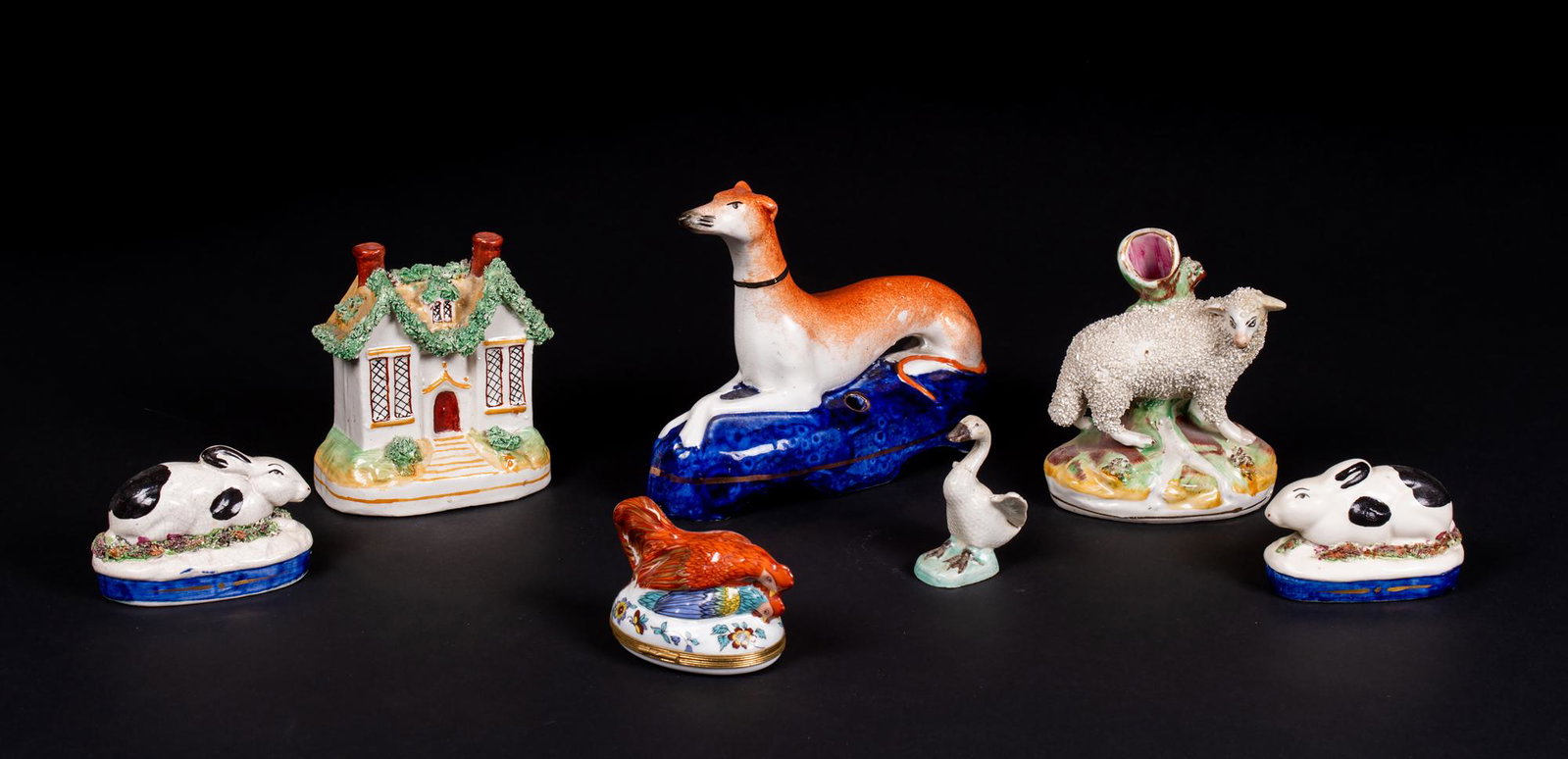Lot of Miscellaneous English Staffordshire Pottery: Lot of Miscellaneous English Staffordshire Pottery, To include: Pair of 3 1/4" oval rabbits, sheep with tree trunk flower holder 5" tall, recumbent whippet pen holder which is 7 1/2" wide, double chim