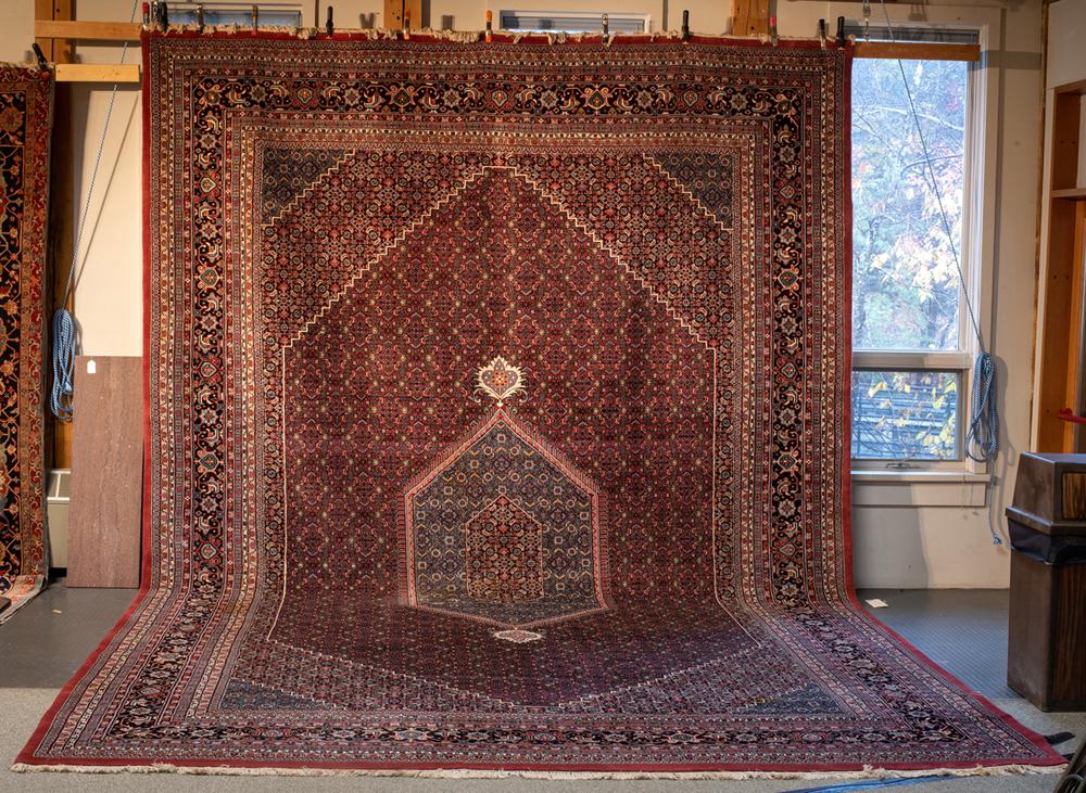 Large Pakistani/ Kazvin Oriental Rug: Large Pakistani/ Kazvin Oriental Rug, Having a blue diamond center medallion on a flower filled red field with cut corners, multiple floral borders, very good condition, 2nd half of the 20thC, comes f