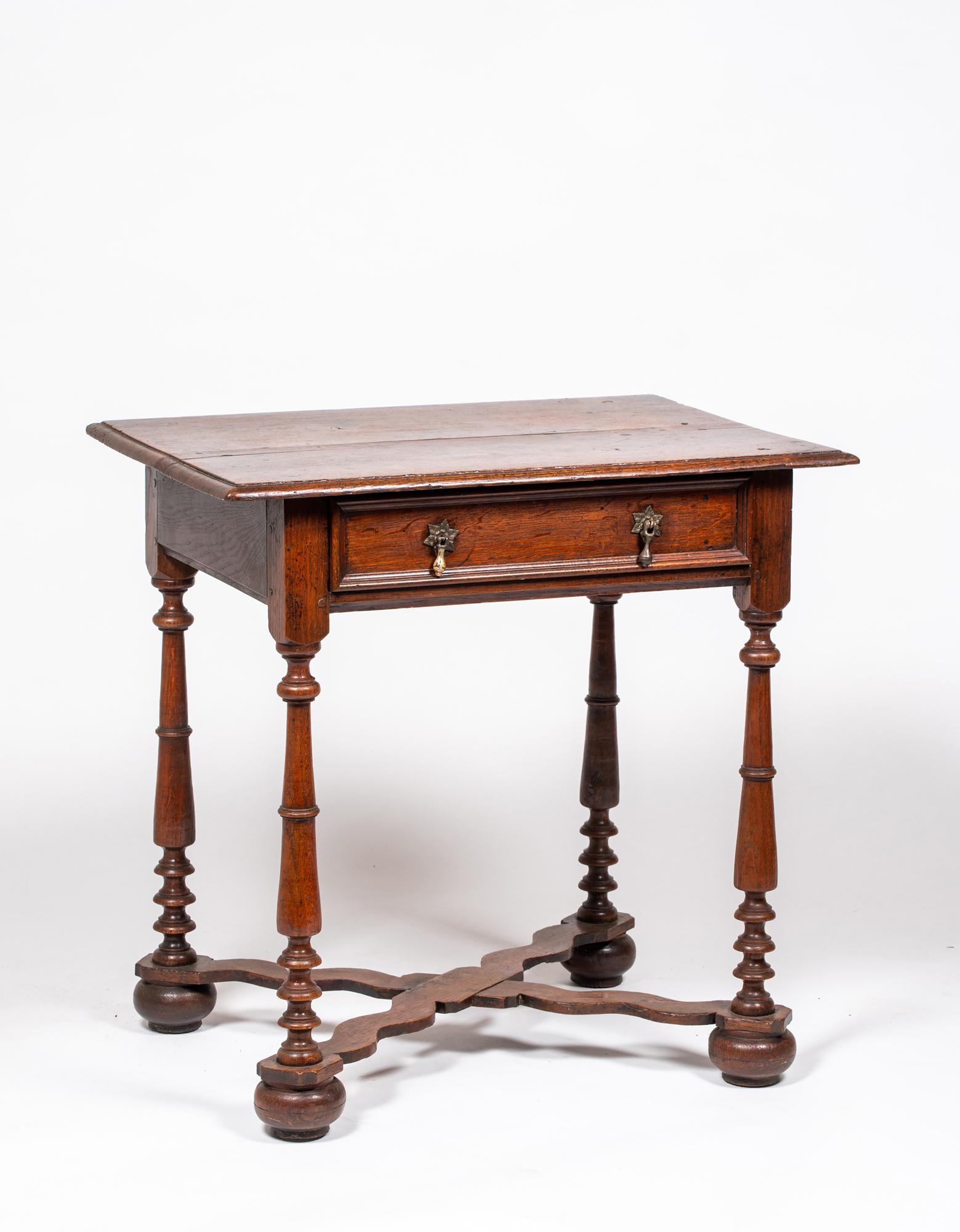 English William and Mary Oak Dressing Table: English William and Mary Oak Dressing Table, Having a rectangular mold edge two board top over a case with a single wide drawer with applied molded front, vase and ring turned legs, with a cross stret
