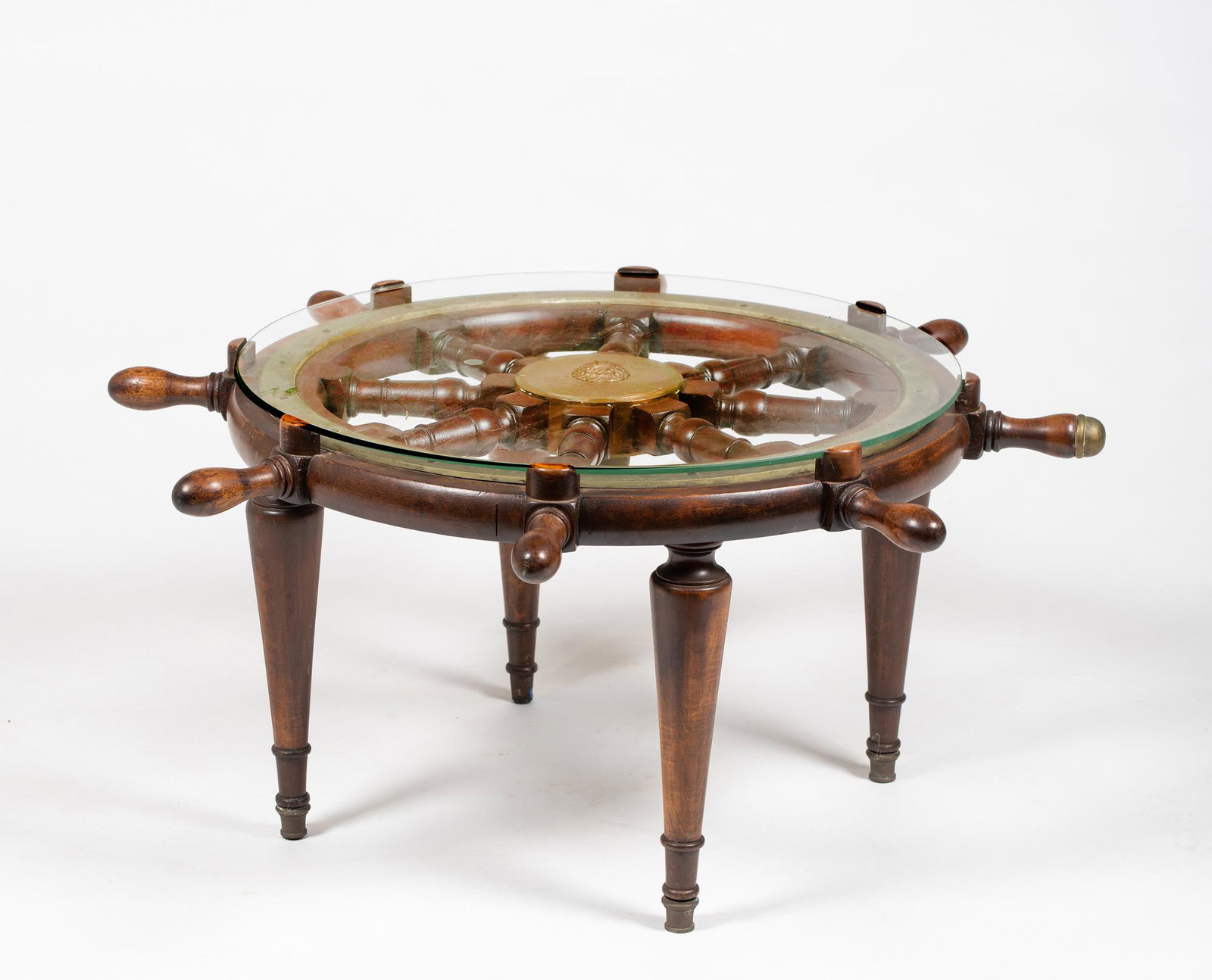 Vintage Ships Wheel Coffee Table: Vintage Ships Wheel Coffee Table, 37" diameter wheel with a round glass laid on the top supported by four turned legs underneath, 17 3/8" tall, very good usable condition, hand joined wheel, probably 