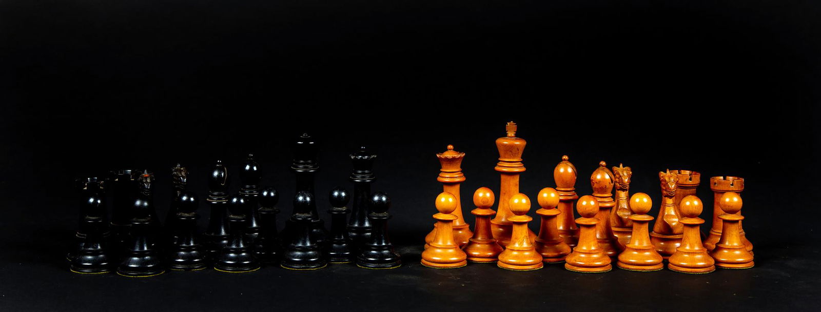 English Ebony and Boxwood Weighted Chess Set: English Ebony and Boxwood Weighted Chess Set, A complete set with the king being 4 3/8" tall, the bottoms filled with lead under a felt bottom, a red stenciled crown on the head of the rook and the ca