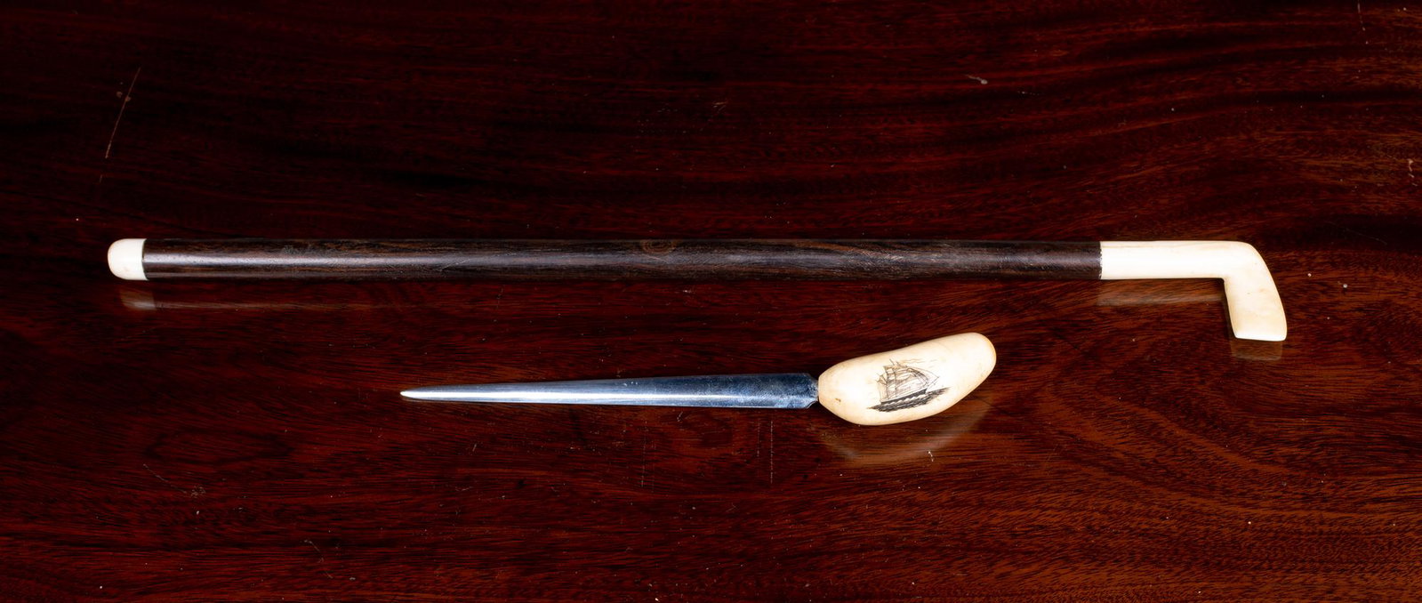 Eskimo or Sailor Carved Letter Opened and Miniature: Eskimo or Sailor Carved Letter Opener and Miniature Golf Club, A) A stainless steel blade inserted into a small whales tooth with a scrimshaw drawing of a sailing ship, 7 1/8" long, mid 20thC. B) 14 1