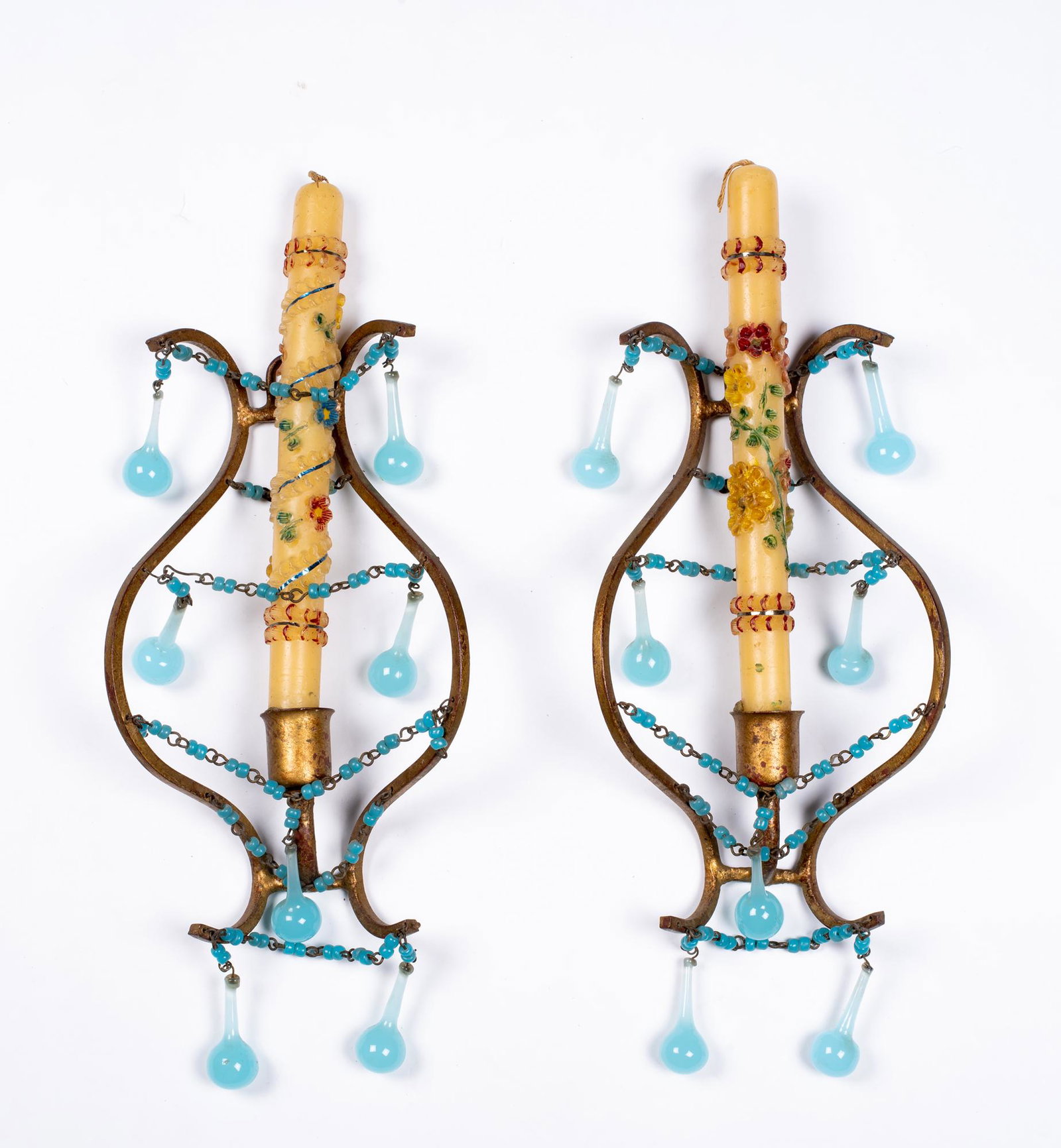 Pair of Bronze and Blue Glass Candle Sconces: Pair of Bronze and Blue Glass Candle Sconces, Having a bronze hanging skeleton with a candle socket which has blue glass bead and ball drops hung along the frame as decoration, in addition it has two 