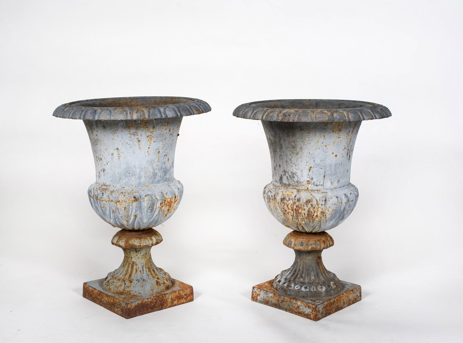 Pair of Two Part Fluted Urns 20 1/4" Tall: Pair of Two Part Fluted Urns 20 1/4" Tall, Having a fluted bowl with petal flaring rim top, 15 1/2" diameter, old flaking gray paint, good condition with rusting, no chips or cracks, also from Parker 
