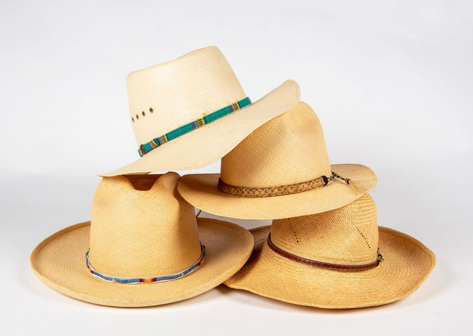 Four Straw Cowboy Style Hats: Four Straw Cowboy Style Hats, Two labeled "Monte Criste", one labeled "Quaker Marine Supply", two have snake skin and horse hair bands, one with polychrome woven grass and hide, one with polychrome wo