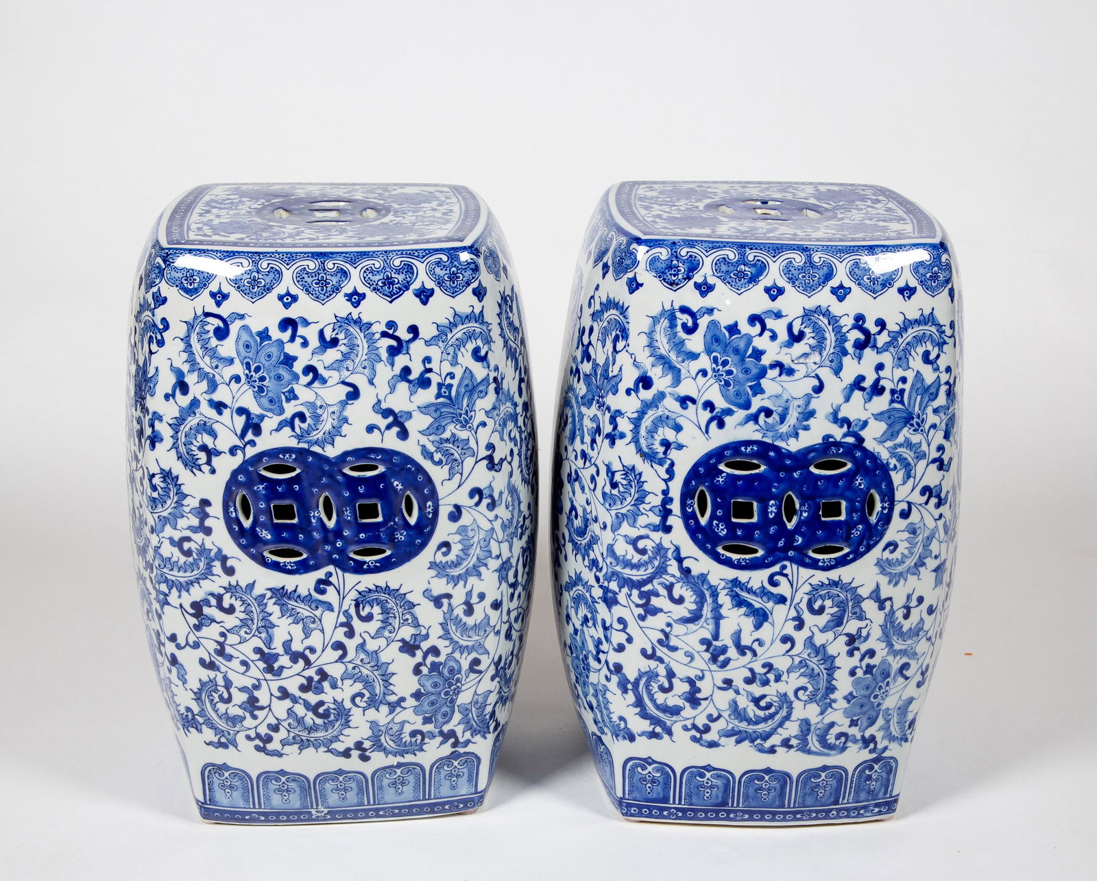 Pair of Chinese Porcelain Garden Seats: Pair of Chinese Porcelain Garden Seats, Blue and white floral decoration, pierced top, square bulbous form, 19" tall x 10" square, probably 20thC. Estimate: $200 - $300