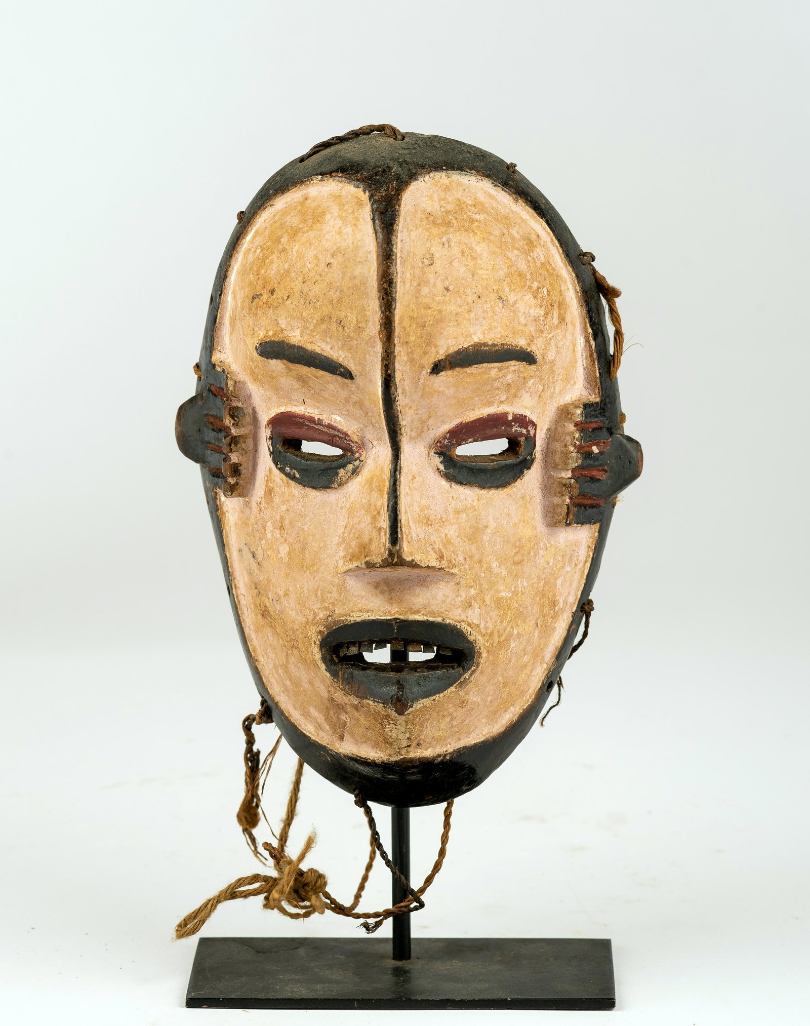 An Ibo/Igbo Mask, Nigeria: An Ibo/Igbo Mask, Nigeria, on base, height: 8 1/2". Provenance: Irv Fischer Collection, Michigan