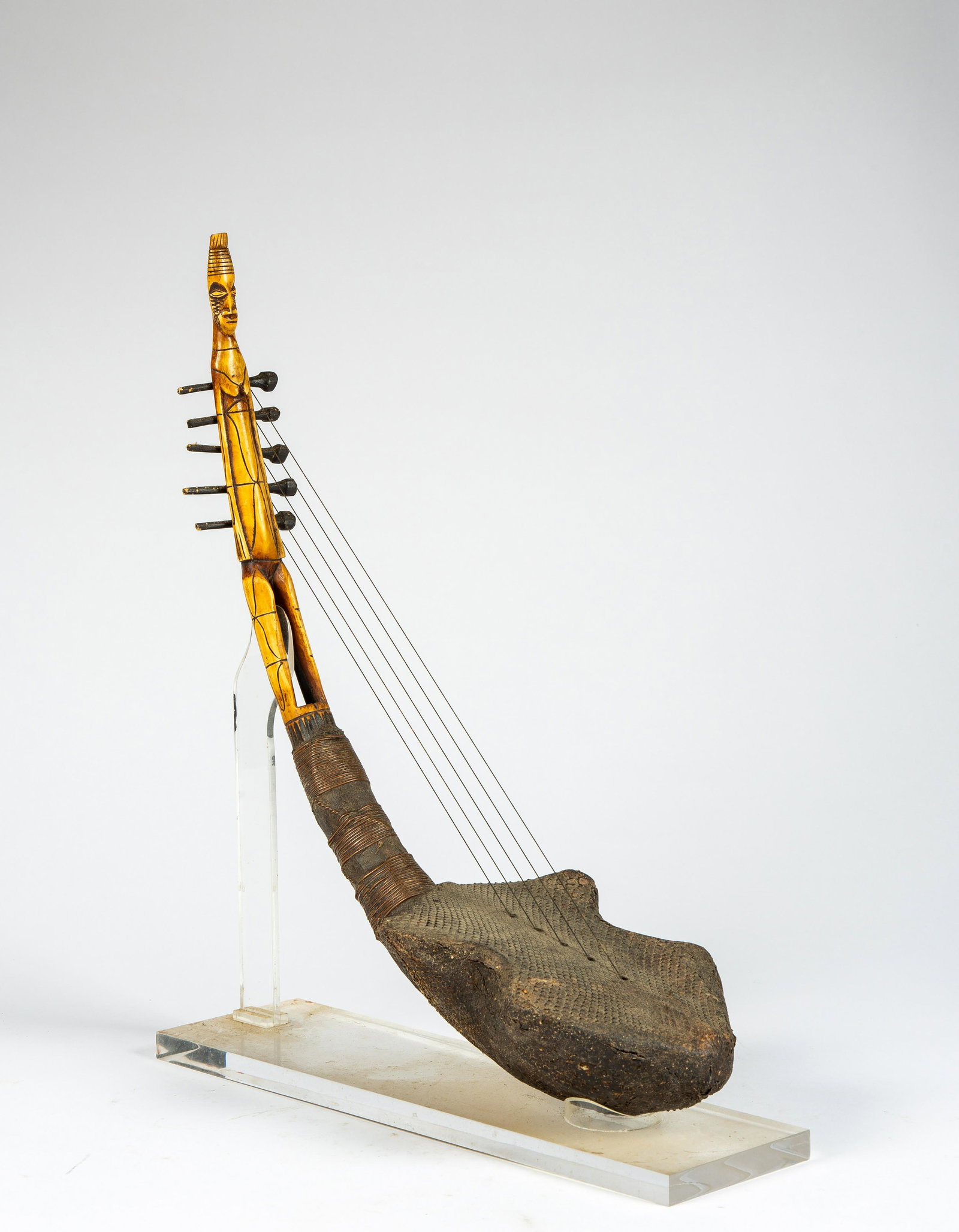 A Mangbetu Figural Harp, DRC: A Mangbetu Figural Harp, DRC, of bone, copper and snake skin length: 24". Provenance: Irv Fischer Collection, Michigan