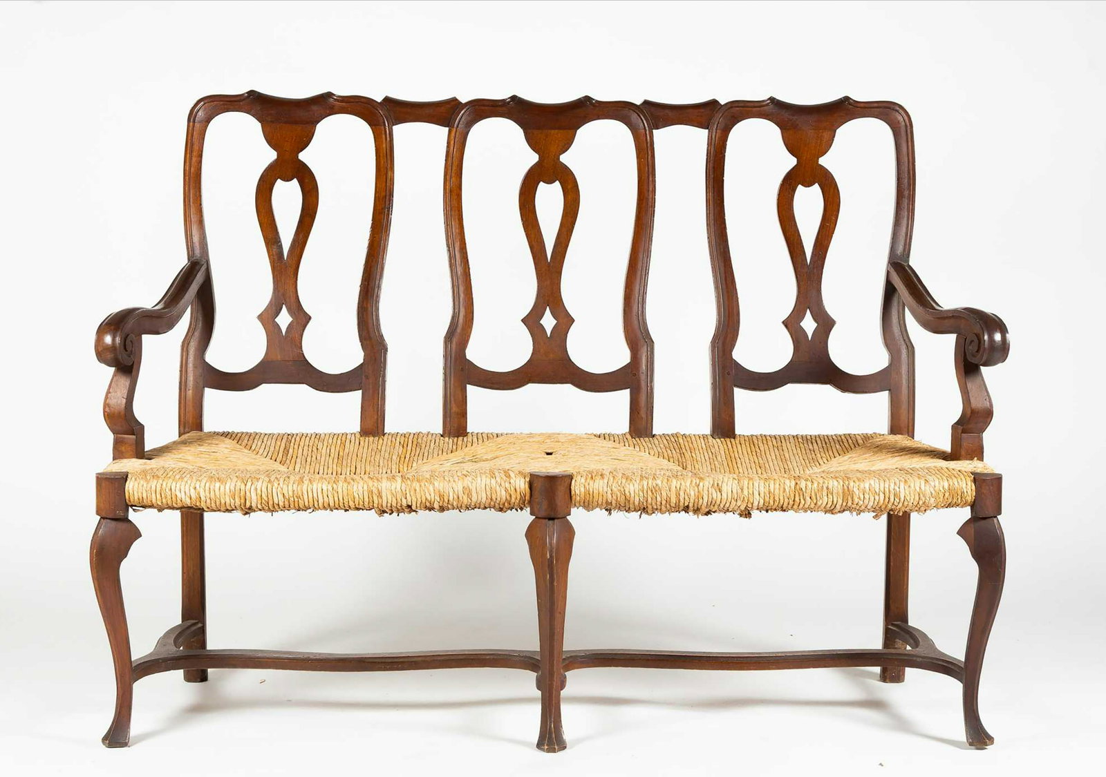 Queen Anne Style Settee, Three shaped backs above a woven rush seat, scrolled arms, stretcher base: Queen Anne Style Settee, Three shaped backs above a woven rush seat, scrolled arms, stretcher base with three trifid front feet, 4' 8" wide x 18 1/2" deep x 40" tall, 17" seat height, 20thC.