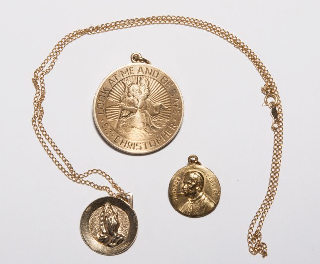Yellow Gold Religious Medallions.: Yellow Gold Religious Medallions: praying hands medallion and 16" chain marked, 14K; "St. Christopher," and "Look at Me and Be Safe," locket medallion marked inside 14k; "Sanctus Pius X," and Christ m