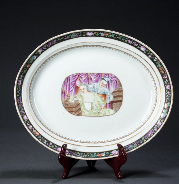 Chinese Export Platter, 15 1/2" long oval with scene of: Chinese Export Platter, 15 1/2" long oval with scene of partially dressed woman and her maid, with a black floral border, probably 18/19th century for European Market.