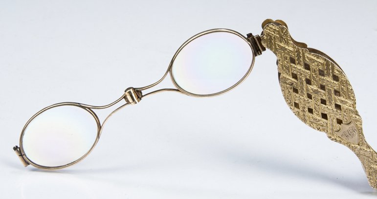 Yellow Gold Lorgnette: Yellow Gold Lorgnette, unmarked but tested AT 10K, it features an open work woven design, glass still intact, approximately .68 troy ounces with glass, 19th century.