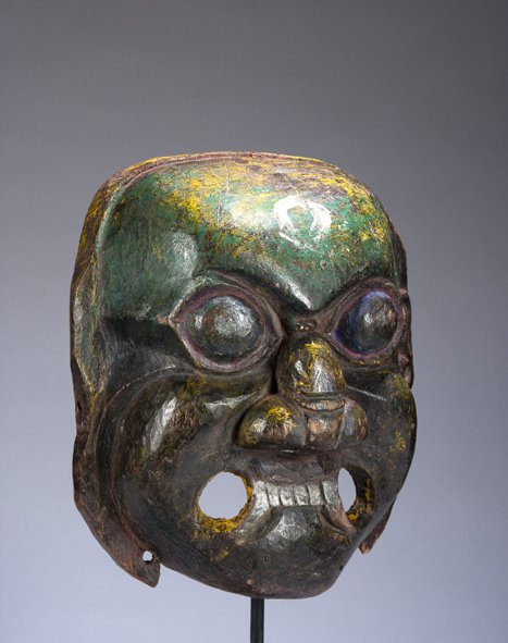 A Fine Wooden Deity Dance Mask from Nepal or Bhutan: A Fine Wooden Dance Mask of a Wrathful Deity, Nepal or Bhutan, Late 19th or Early 20th Century, the mask powerfully carved in wood, representing one of the wrathful Tantric deity- protectors of the fa