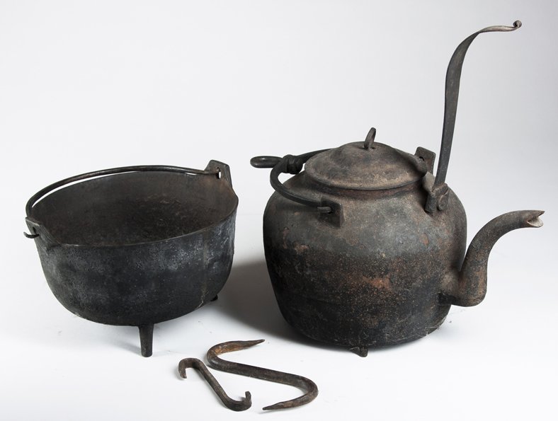 Four Pieces of Cast and Wrought Iron: Four Pieces of Cast and Wrought Iron, a tipping kettle with low feet; a small footed pot and two "S" hooks, 18/19th century.