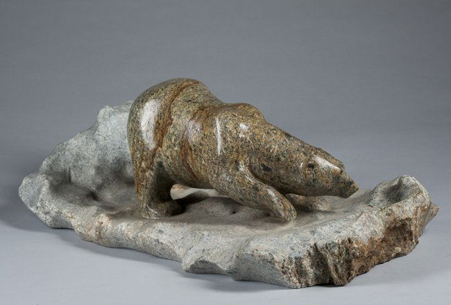 Inuit carved Stone Polar Bear: James Lange, 20th Century, Canada, Inuit carved polar bear depicting a bear travelling on an ice float (carved stone base), signed on the edge, James Lange," 10" x 18 1/2".