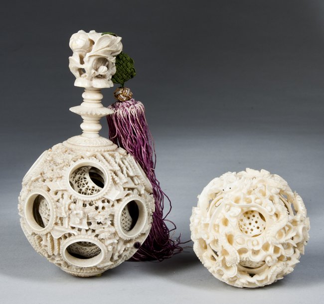 Lot of Two Chinese Ivory Puzzle Balls: Lot of Two Chinese Ivory Puzzle Balls: A - A 2 3/4" in diameter ball with pierced carved dragons surrounding 7 or 8 inner pierced carved balls. Outer ball is in excellent condition, while many of the 