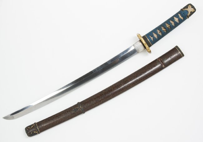 Japanese Signed Wakizashi Length Ancestral Sword: Japanese Signed Wakizashi Length Ancestral Sword. The Sword's blade shows a large grain pattern throughout and a straight Hamon (hardened portion of blades edge). The nicely proportioned blade appears