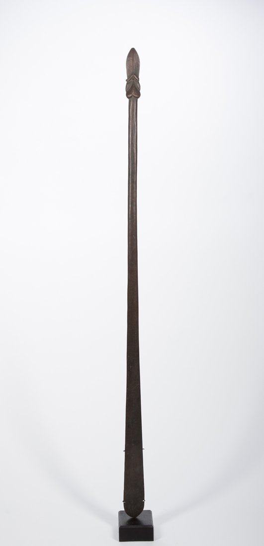 An unusual Maori Taiaha: Maori, New Zealand; L: 53 1/2" The piece fine and old but though classically blocked, only one small line of carving has been cut into it, in what appears to be stone or shell cutting. Overall fine pa