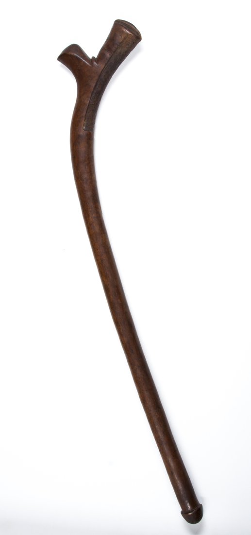 A Fijian gunstock club: Fiji; H" 31" A small gunstock form club, with typical spur to the upper edge and roughened portion to the inner curved surface. Deep reddish-brown patina from handling. Possibly made for a child. Fine