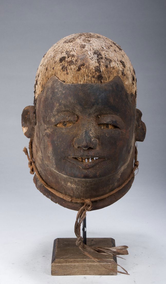 A fine Makonde Lipiko mask: Makonde, Tanzania/Mozambique; H: 10 1/2"The naturalistically carved helmet mask with roughened area once covered with human hair, the face with heavily lidded eyes and naturalistic nose and mouth. The