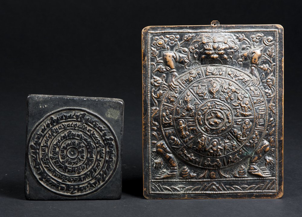 A Tibetan Copper Gau Plaque: A Tibetan Copper Gau Plaque and a Wooden Print Block. The plaque in the form of a wrathful deity holding a circular wheel with images of a mythological Tantric importance. Well done hammered design, t