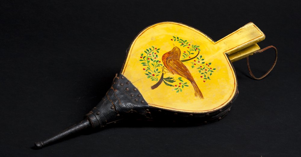 "Shaker" attributed Painted Bellows: "Shaker" attributed Painted Bellows. Yellow painted leather and wood bellows from the early 19th century, which was then painted later with a bird in a tree in the shaker manner, 19 1/2" long.Estimate