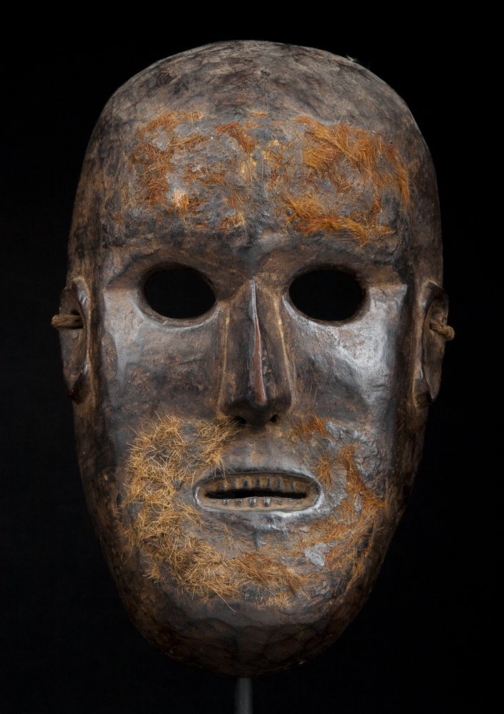 A Nepalese Mask: A Nepalese Mask, Nepal, middle hills, probably Tamang/Magar, the mask with dark encrusted patina and remains of panels of animal fur representing facial hair, 10 1/2". Estimate: $500 - $900