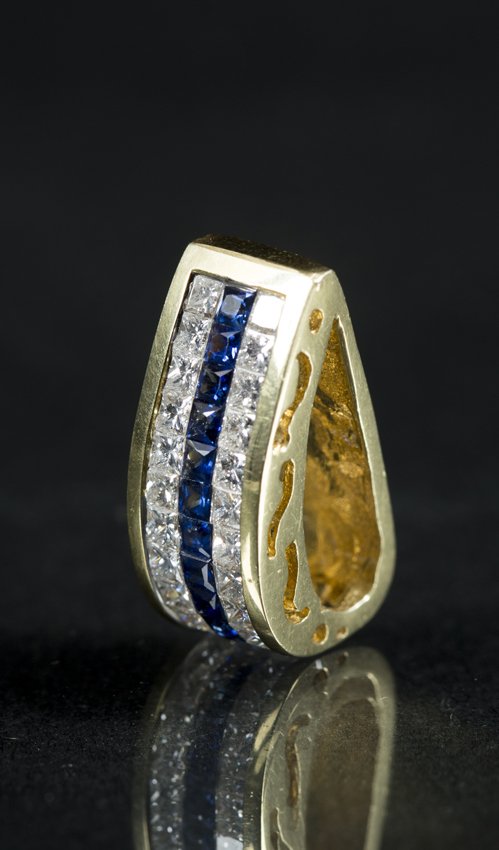 Diamond Sapphire and Yellow Gold Pendent: Diamond Sapphire and Yellow Gold Pendent, marked 18K, pendent has a flat back with a bowed out face set with two rows of square cut diamonds totaling 26 (channel set), and a single row of 13 square cu