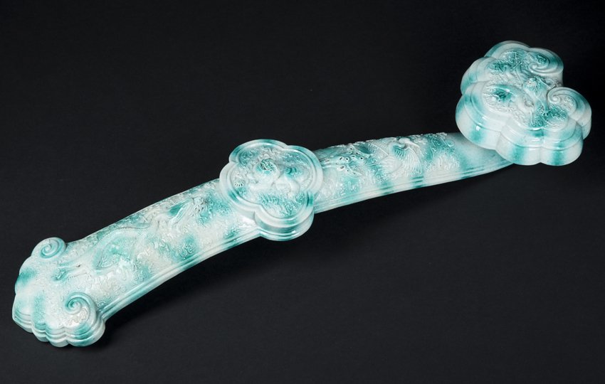 Chinese Porcelain Scepter: Chinese Porcelain Scepter, decorated to resemble carved jade with raised relief dragons, bird and a Shishi, 19 1/2" high, 18th/19th century, has two horizontal breaks that have been restored, small ch