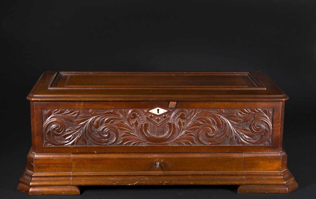 Ideal Piccolo Swiss Music Box: "Ideal Piccolo" Swiss Music Box, mahogany carved front case, patent dated works 1888, comes with a lower drawer which holds 3 cylinders all teeth in tact, 27 3/4" w x 13" Dc 10 1/2" tall, in working c