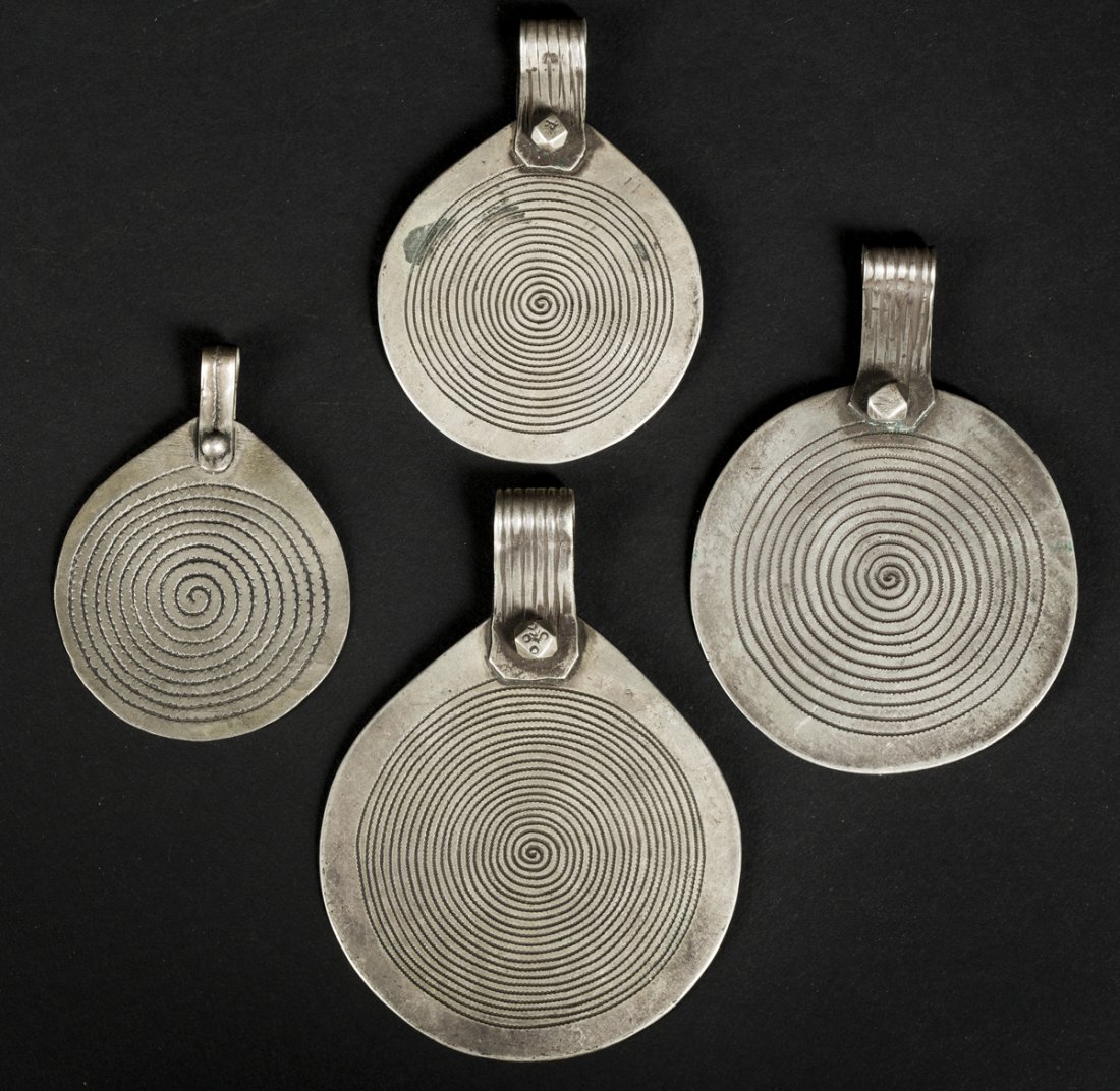 Four Tuareg Demon-catcher amulets: African Art Four Tuareg Demon-catcher amulets. Tuareg, Niger and Mali, Diameters: 1.5-2.5". The four flat pendants with a circular design that spirals very finely into a central point – used by 