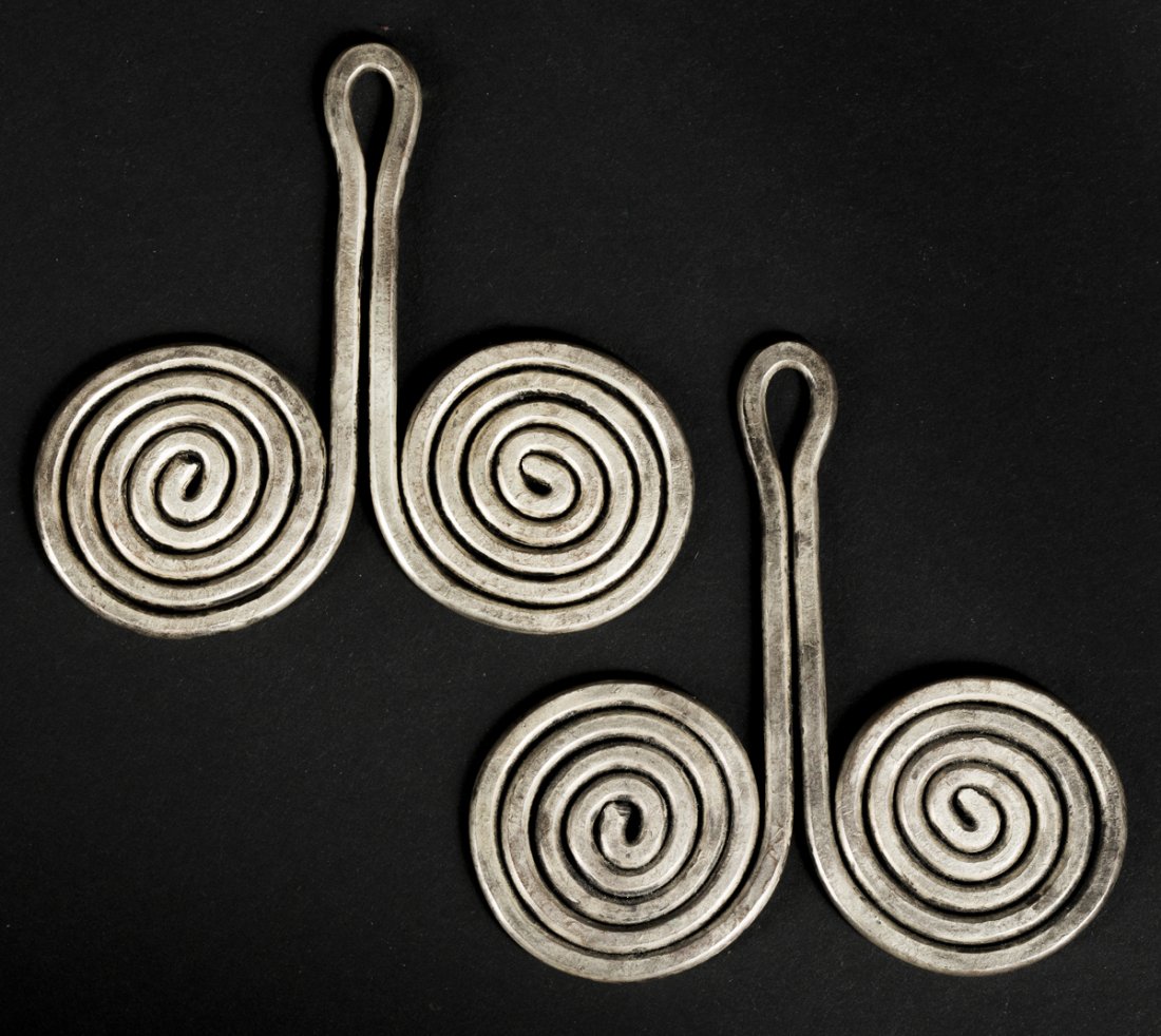 A Pair of Batak Padung Padung: Asian Art A Pair of Batak Padung Padung. Batak, Sumatra; Indonesia. H: 3.25. The heavy earrings in the form of double spirals with a central apex emerging from them, of obvious phallic form. These are
