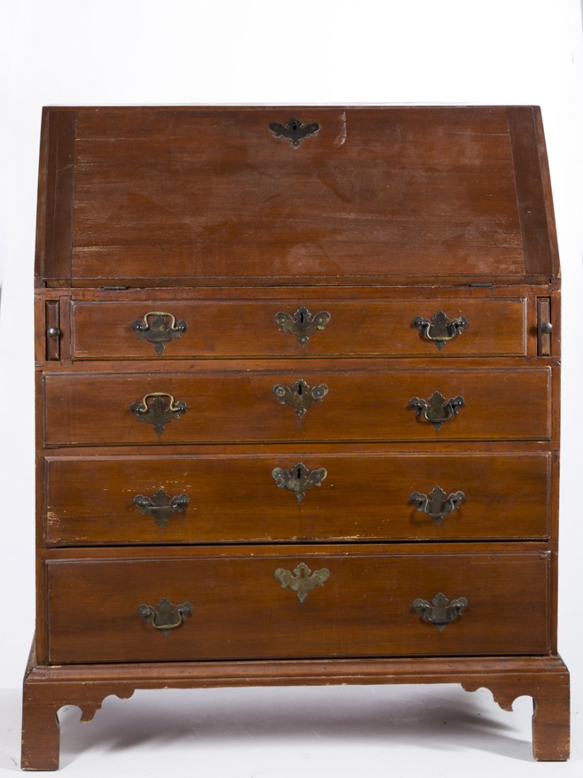 Maple Chippendale Slant front Desk: Maple Chippendale Slant front Desk, a fold down lid opening to reveal a cubby over drawer interior with shaped valences over a case with four lipped drawers, some lip repair, damage to lid, and replac