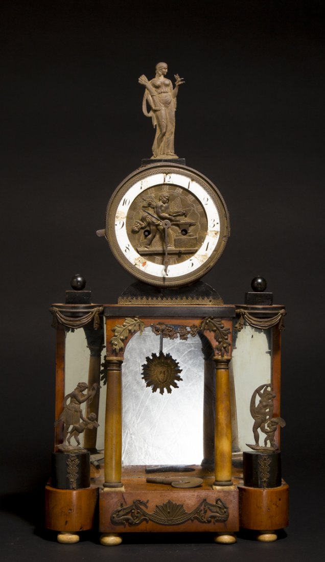 Biedermeier Shelf Clock: Biedermeier Shelf Clock, a round birch veneer case at the top holds the brass time and strike works having a Putto blacksmith figural dial with sun form pendulum and classical pressed brass figural fi