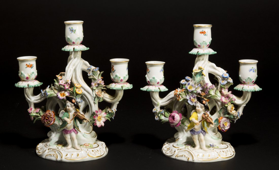 Two Similaiar Meissen Candleabra: Two Similaiar Meissen Candleabra, each having a three socket branched candleholders covered with little flowers and a young girl dancing on one side and a young boy playing the violin on the other. Ea