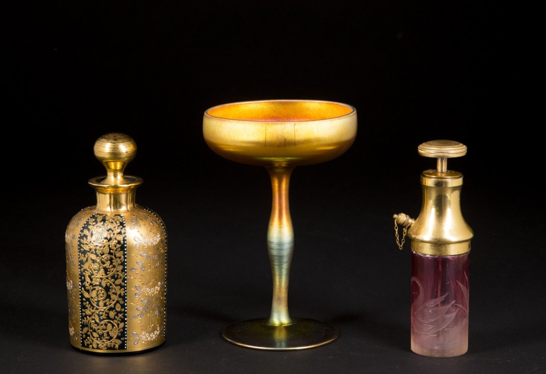 Art Glass Lot of Three: Art Glass Lot of Three: 1) Aurene marked goblet in irredescent gold finish, etched name on bottom, 5 7/8"T 2) blue glass stoppered bottle, 5 1/2" T, gold overlay alternating panels of flowers, C1900 p