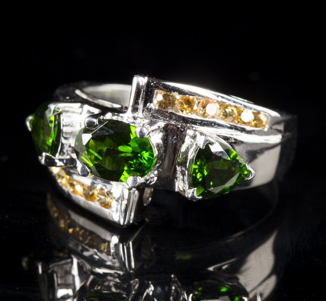 Chrome Diopside and Yellow Sapphire Ring: Chrome Diopside and Yellow Sapphire Ring, 3 diopsides totaling approx. 1.70 carats with approx. .62 carat sapphires, size 6.5, 20th/21stC.Estimate: $300 - $500
