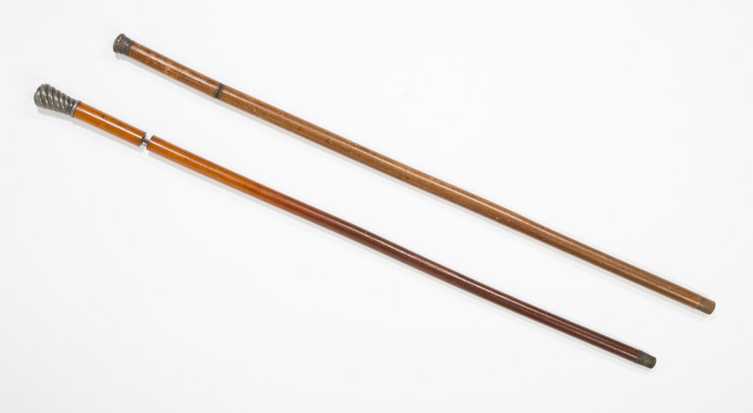 Sword and Flask Canes: Sword and Flask Canes, a) twisted German silver knob, wood two part shaft which twists apart to reveal a glass tube with a fitted metal and cork top, 35.5 "T.Estimate: $200 - $300