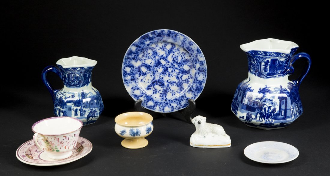 English Porcelain Lot: English Porcelain Lot: two Victorian ironstone pitchers, 5 1/2" and 7" t with blue and white decoration; a 2 1/2" t staffordshire recumbant sheep; a pink luster cup and saucer; a 2 1/4"t footed mochaw