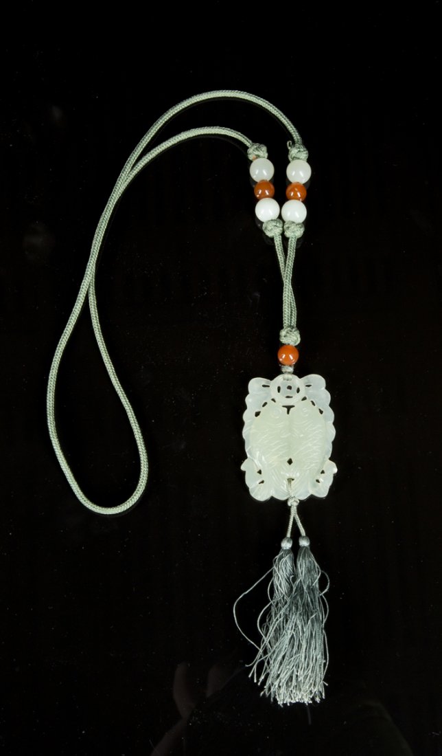 White Jade Pendant: White Jade Pendant, carving of two goldfish on a silk tassel cord, and 7 beads, 4 white Jade and 3 carnelian, 19 1/2"L, 19th/20thC. Estimate: $200 - $300