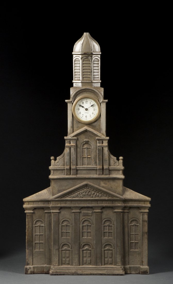 Cast Iron Philadelphia City Hall Clock: Cast Iron Philadelphia City Hall Clock, representing the building destroyed by fire in 1885, 19 1/2"T, old paper label on back-stained, "Liberty" German wind up clock in steeple. Estimate: $150 - $250