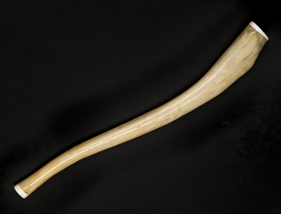 Walrus "Oosik" Bone: Walrus "Oosik" Bone, the 17"L antique Baculum bone from the walrus penus have been capped with Ivory at each end, 19/20thC. Estimate: $200 - $300