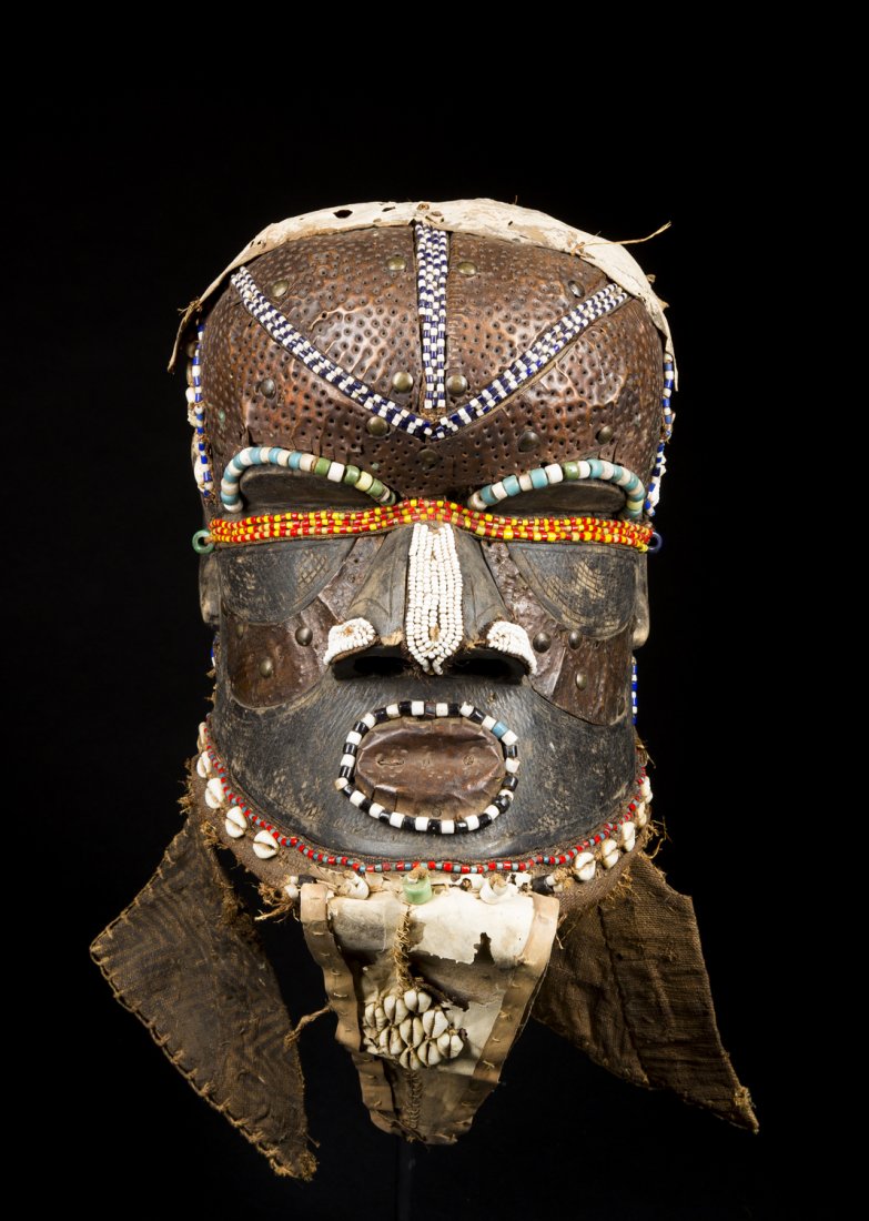 A Fine Kuba Bwoom helmet mask: A Fine Kuba Bwoom helmet mask, Kuba- Bushoong; D.R. CongoThe mask of classical bell-shaped helmet mask form, the forehead covered in copper with beaded strips, the nose with beaded nostrils and centra