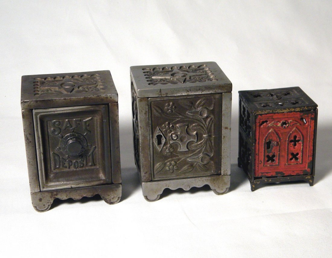Lot of 3 Cast Iron Safe Banks: J. & E. Stevens Keyless Lock Co. No. 50 safe, "Safe Deposit" safe, and Shimer Toy Co. Church Window Safe.